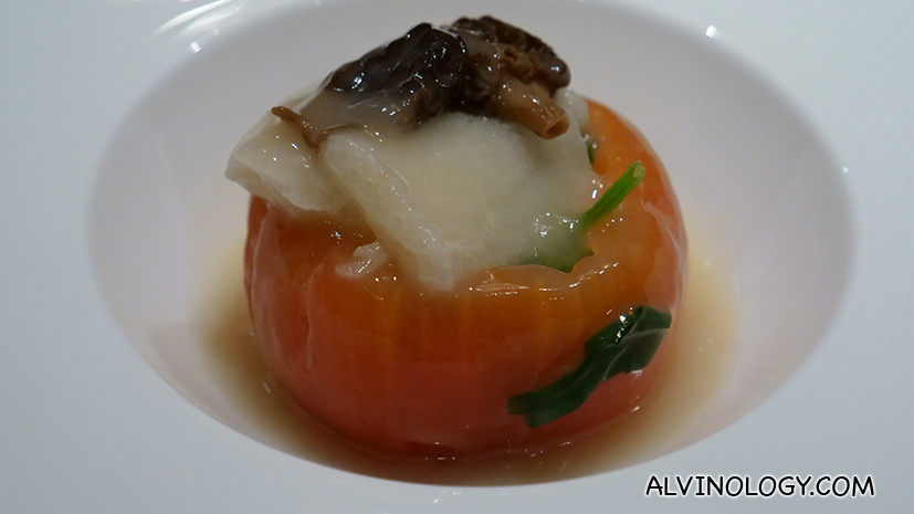 Braised whole tomato filled with seasonal vegetable, morel mushroom and bamboo fungus in chicken broth