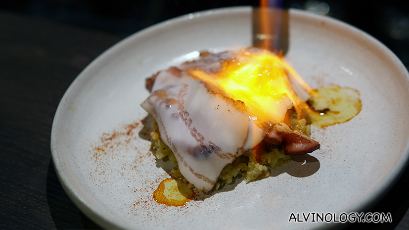 Searing the octopus with a blow torch