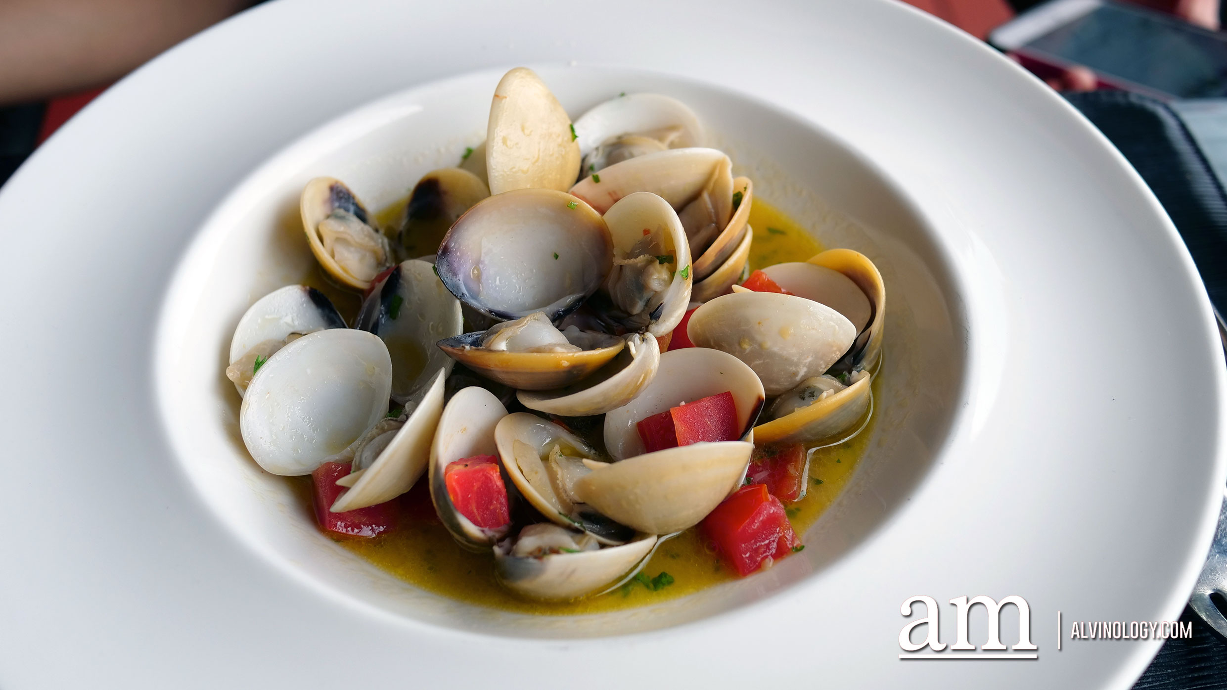 Local Baby Clams Sauteed with White Wine, Garlic, Cherry Tomatoes and Herbs