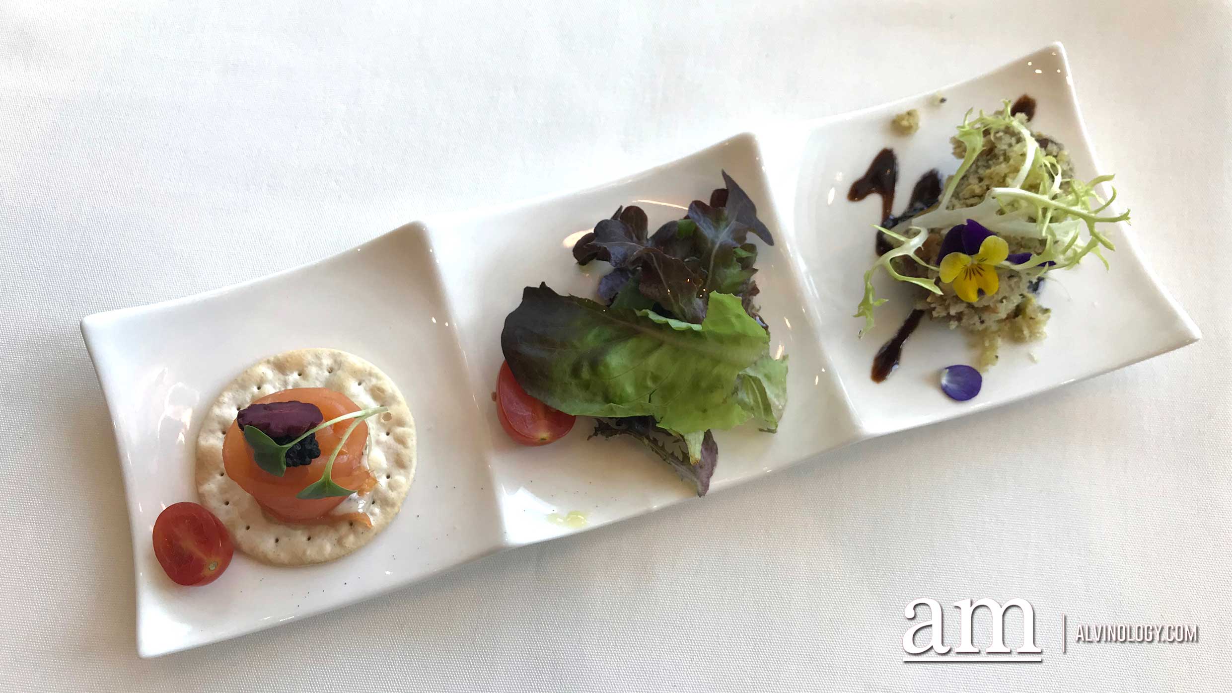 A Treat for Two - Braised USDA wagyu beef cheek with pistachio crust, grilled pineapple and balsamico reduction, yellow frisse and smoked salmon topped with avruga on bed of water biscuit, served with purple cucumber pickles
