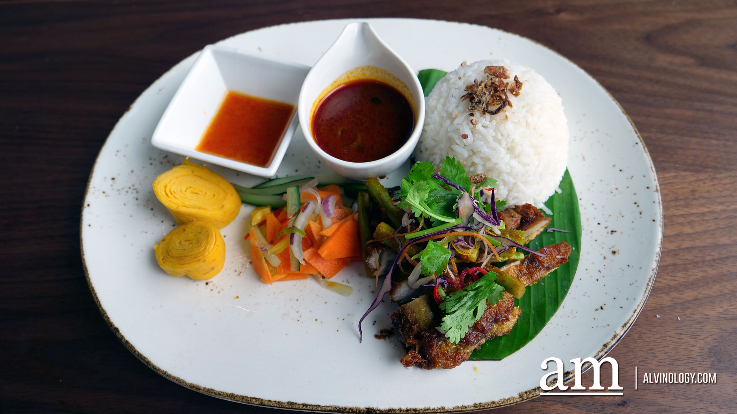 Nasi Lemak Kelapa Dara (RM38) - Extra virgin coconut oil steamed rice, crispy anchovies, onion, peanuts, egg omelette and kyuri. Served with tiger prawn sambal and chicken roulade rendang. 