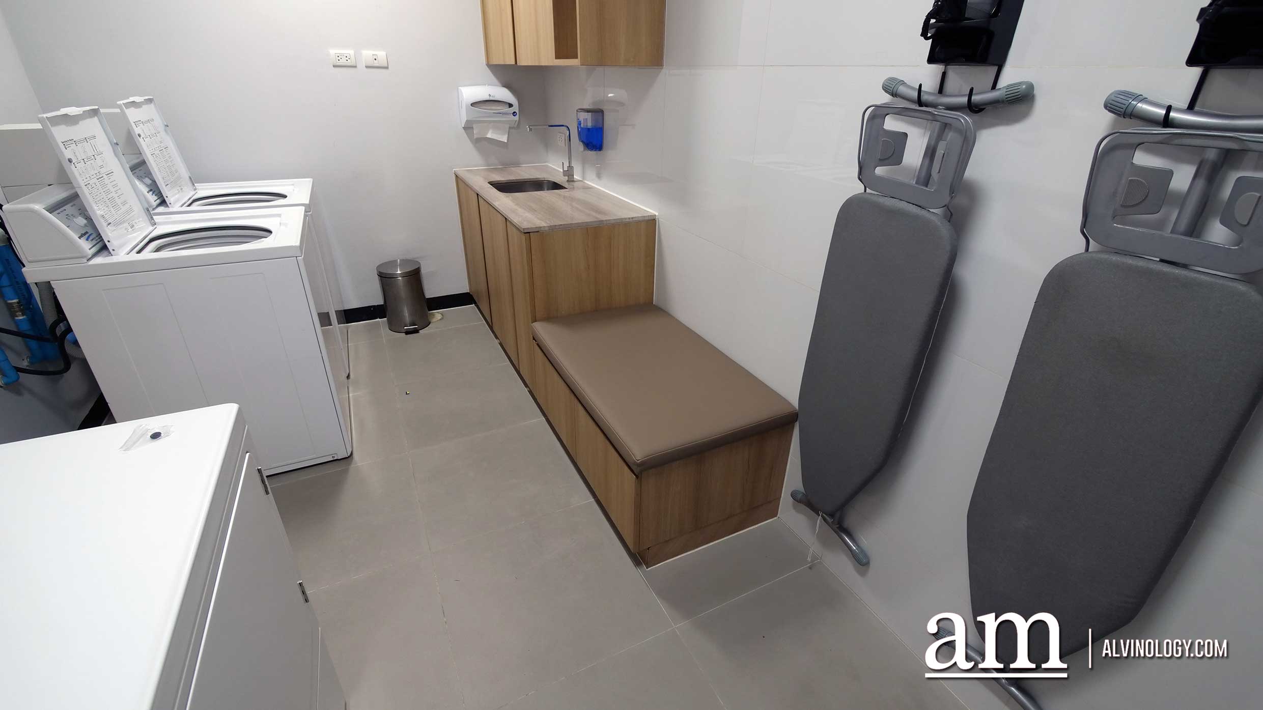 Awesome laundry room with washers, dryers and ironing facilities