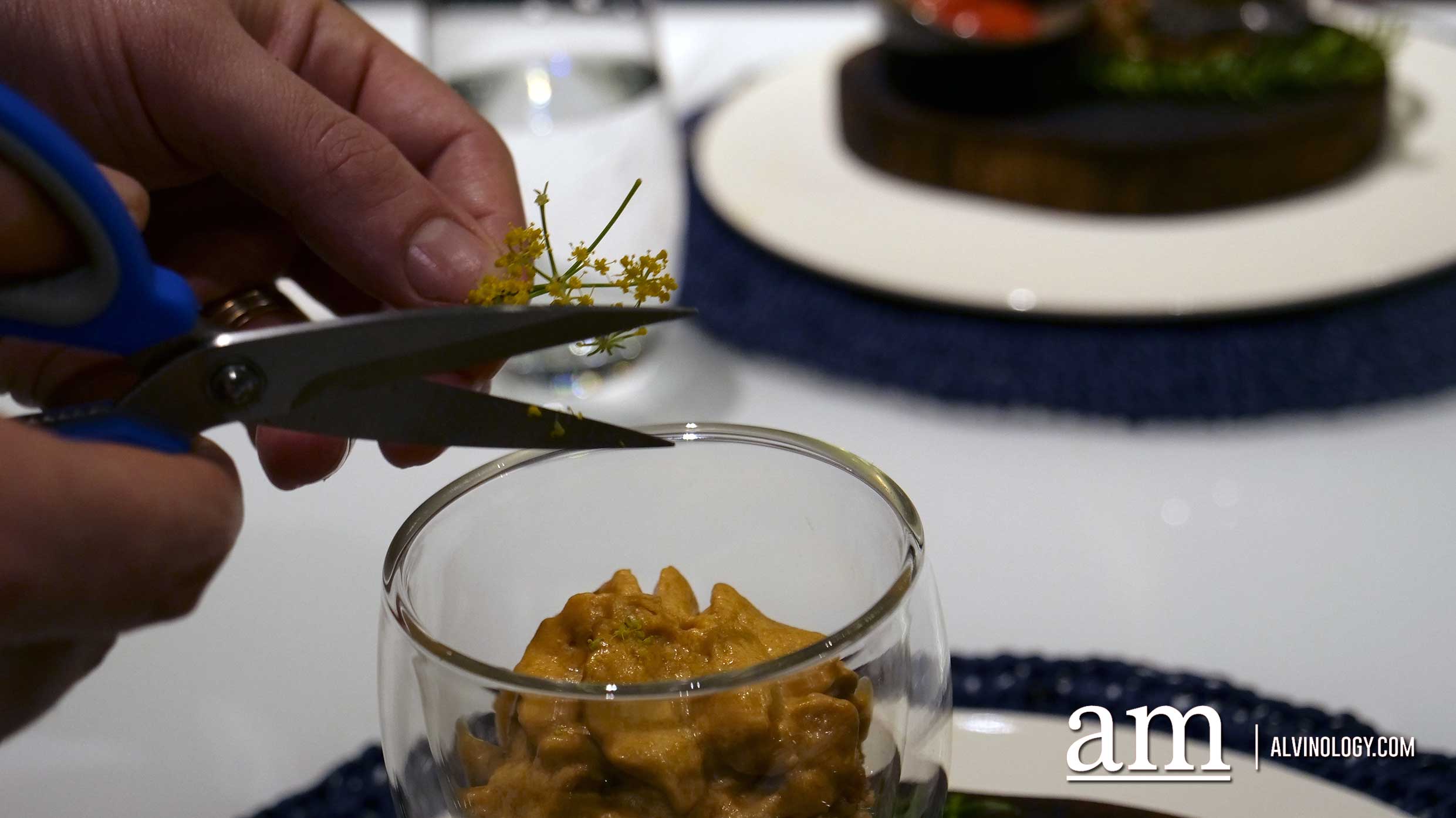 Chef adding in the garnish for the finishing touch