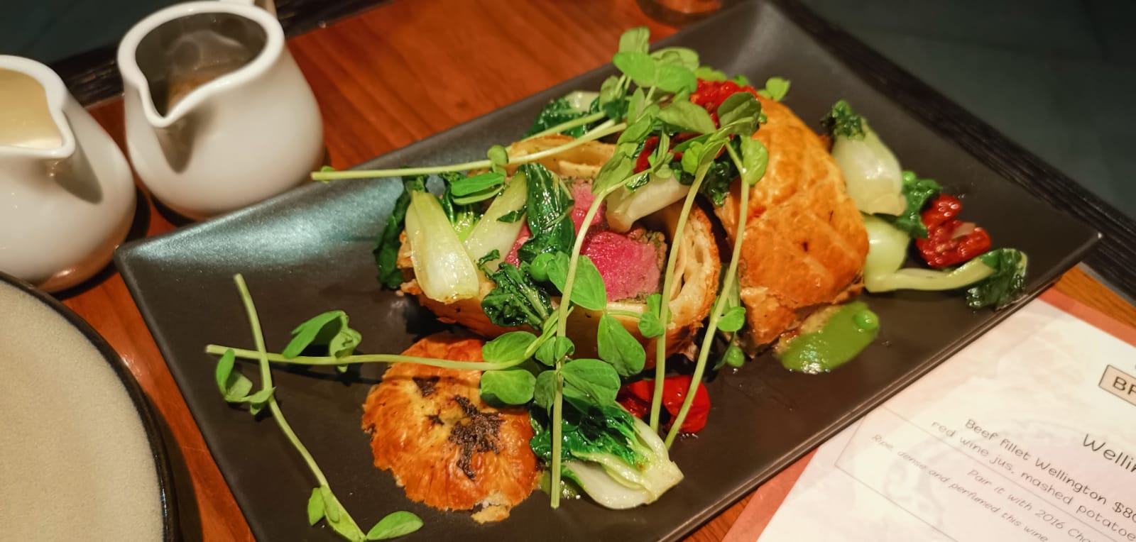 lamb wellington with minted red wine jus, green peas, baby bock choy and sundried tomatoes (S$59++)