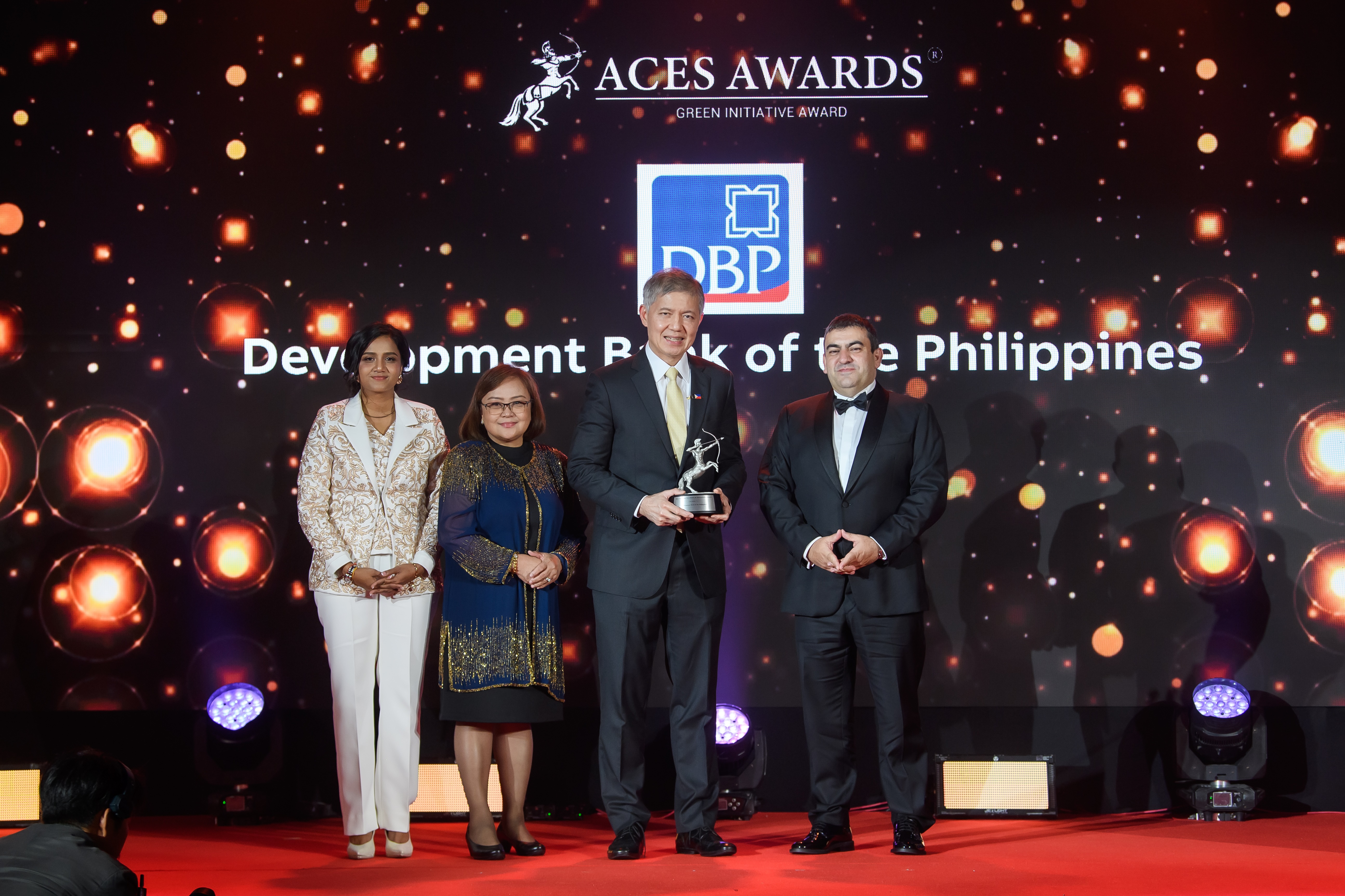 Development Bank of the Philippines Celebrates Consecutive and Dual Honors at Asia Corporate Excellence and Sustainability (ACES) 2024 The Development Bank of the Philippines (DBP) shines at the ACES Awards 2024! Receiving the prestigious Green Initiative Award on Day 1, DBP was represented by Michael de Jesus, President and CEO (right center), and Carolyn Olfindo, SVP/Head of the Branch Banking Sector (left center). The award was presented by Dr. Shanggari Balakrishnan, President of the ACES Awards (far left), and Luis Bueno Nieto, Advisor to the ACES Council (far right). Adding to the celebration, Michael de Jesus was honoured on Day 2 with the Outstanding Leaders in Award, in recognition of his exemplary leadership that continues to drive DBP towards sustainable and impactful growth. DBP leading the way in green initiatives and inspiring leadership!