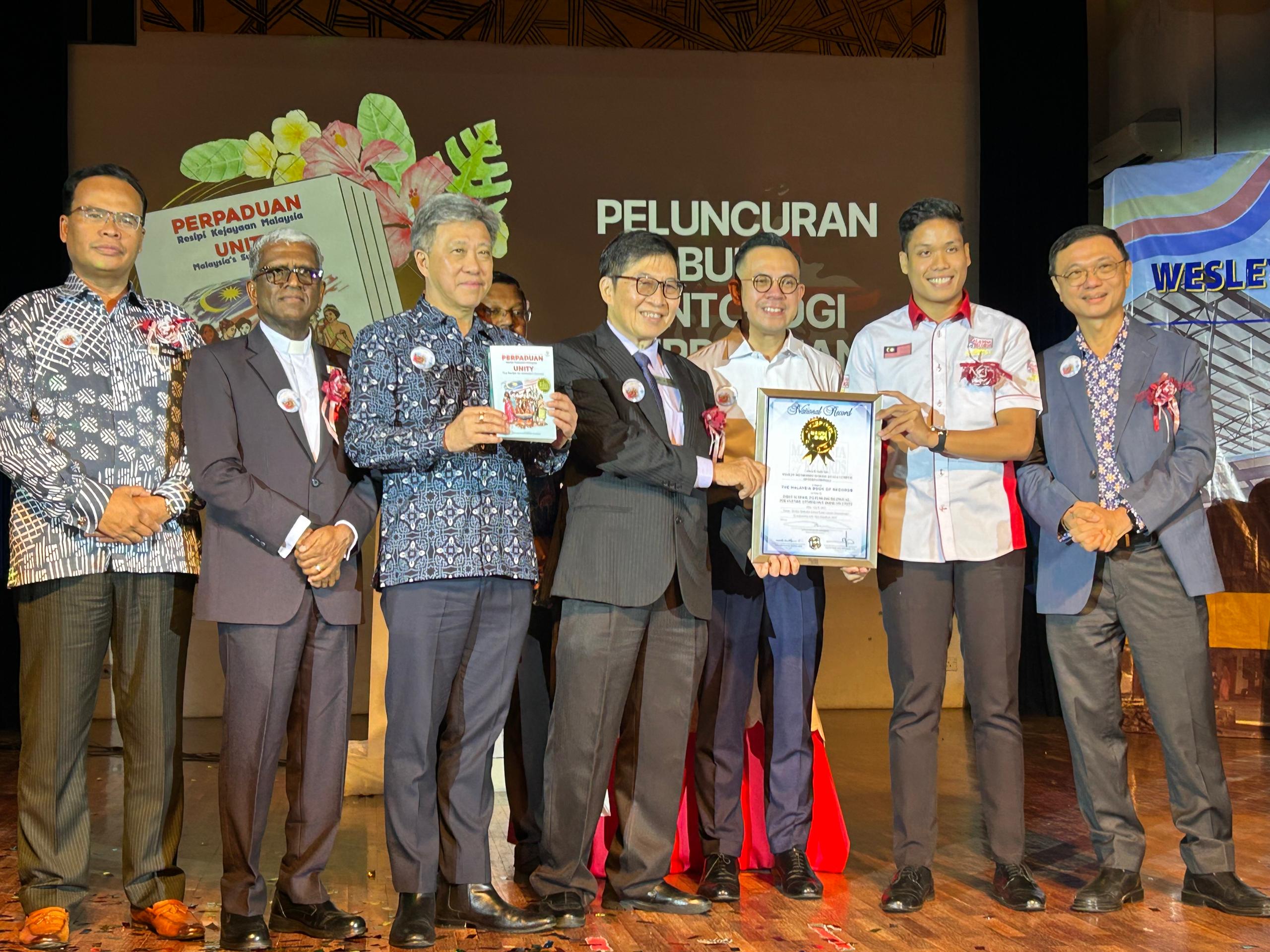 Wesley Methodist School Kuala Lumpur (International) Breaks Record with Unity Anthology, Enters Malaysia Book of Records WMSKLI representatives receiving the official Malaysia Book of Records certificate on stage during the celebration event